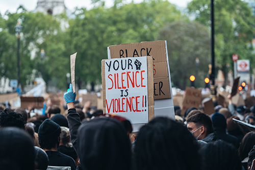 image of protest sign - your silence is violence